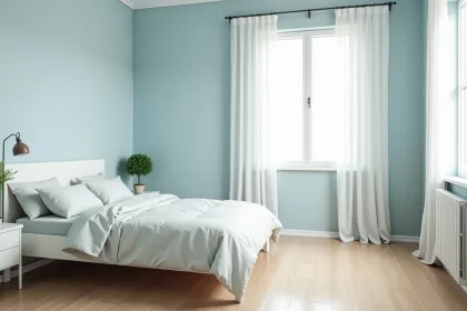 Chambre moderne et cosy avec murs pastel bleu et mobilier blanc